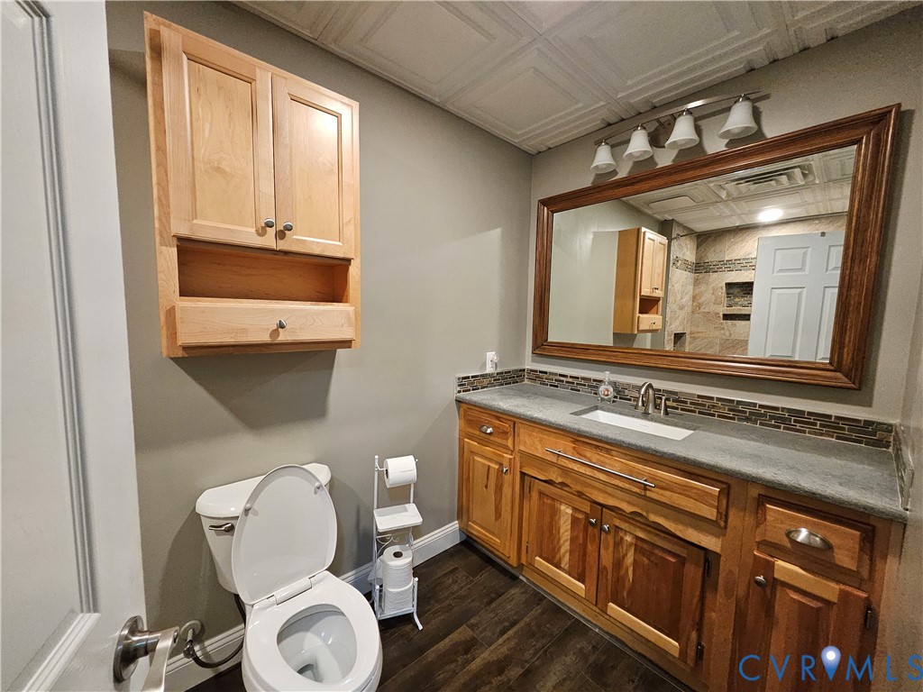 5195 Lennie Road McKenney, VA 23872 - Photo 33 of 45 a bathroom with a toilet a sink and mirror