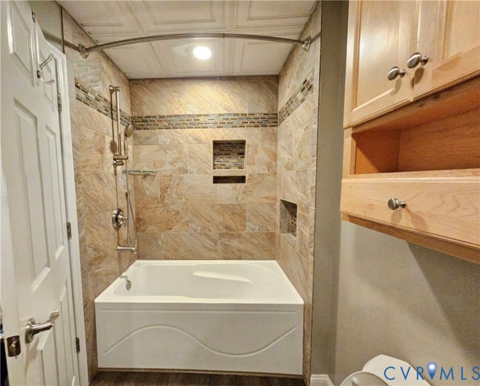 5195 Lennie Road McKenney, VA 23872 - Photo 34 of 45 a bathroom with a tub a mirror and a shower