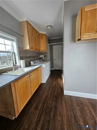 wooden floor fireplace and windows in an empty room