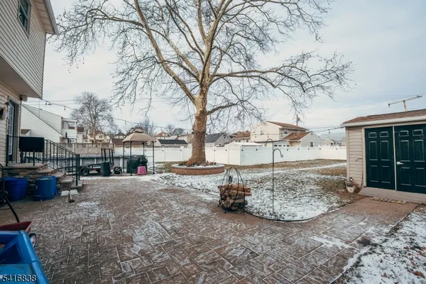 a view of a backyard with table and chairs