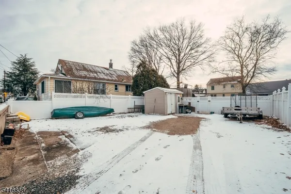 a front view of a house with a yard covered in snow