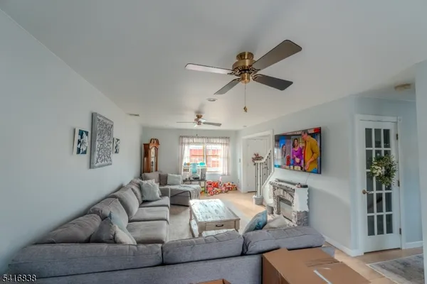 a living room with fireplace furniture and a flat screen tv