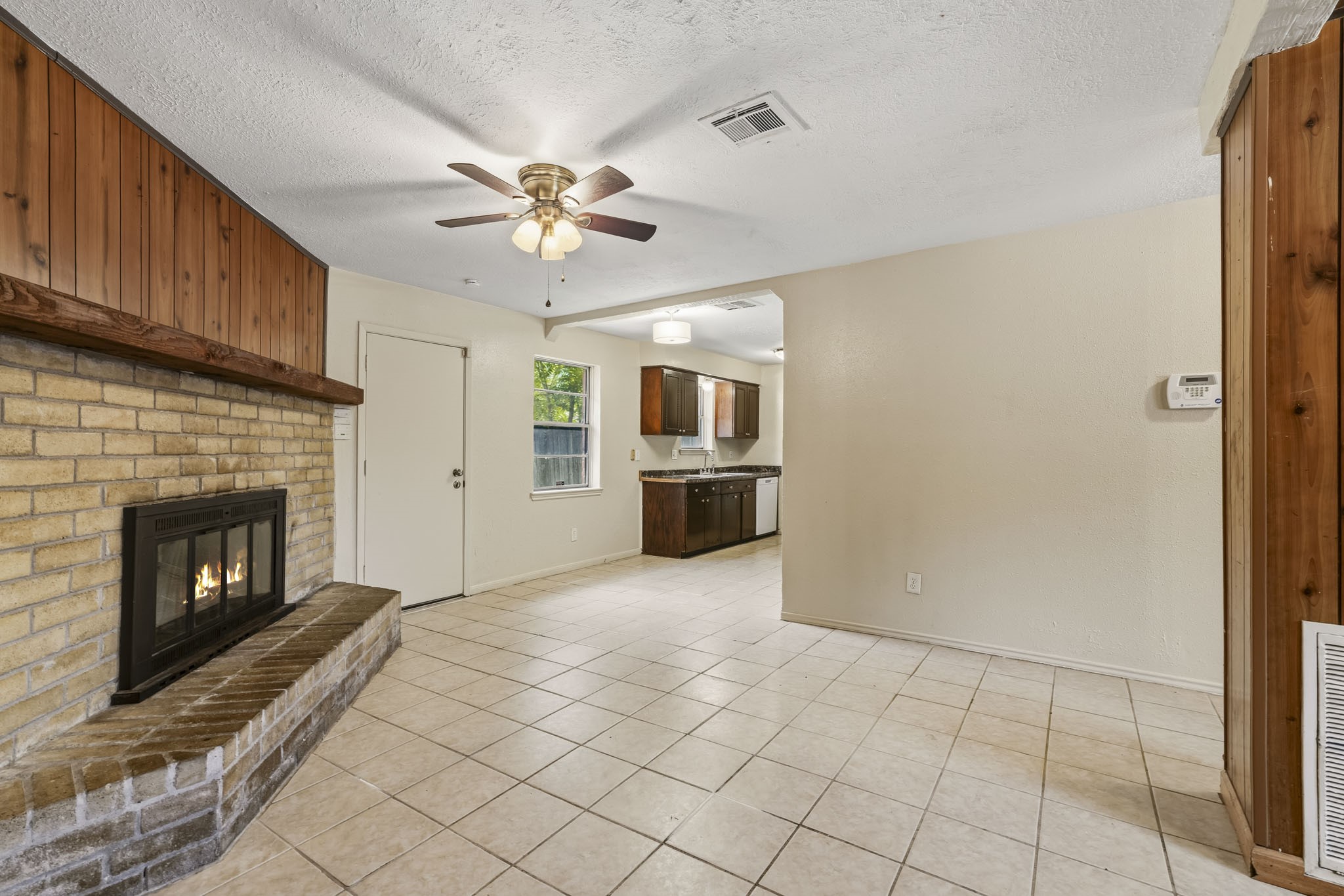 5315 Ridgestone Street Houston, TX 77053 - Photo 7 of 19 Open living area with a brick fireplace and convenient access to the kitchen and the backyard.