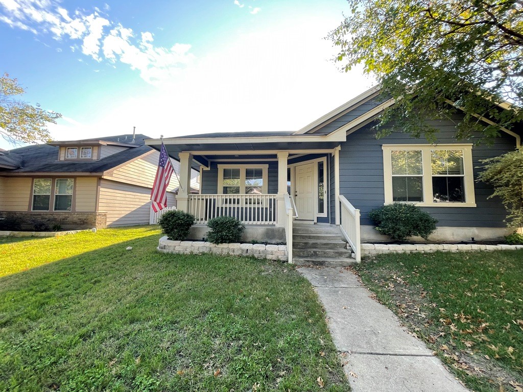 a front view of house with yard and green space
