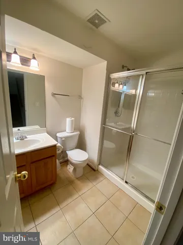 a bathroom with a sink mirror vanity and toilet