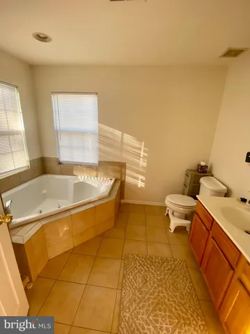 a bed sitting in a room next to a window