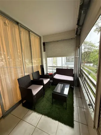 a living room with furniture and a floor to ceiling window