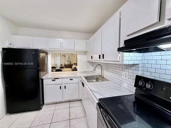 a kitchen with a sink stainless steel appliances and cabinets