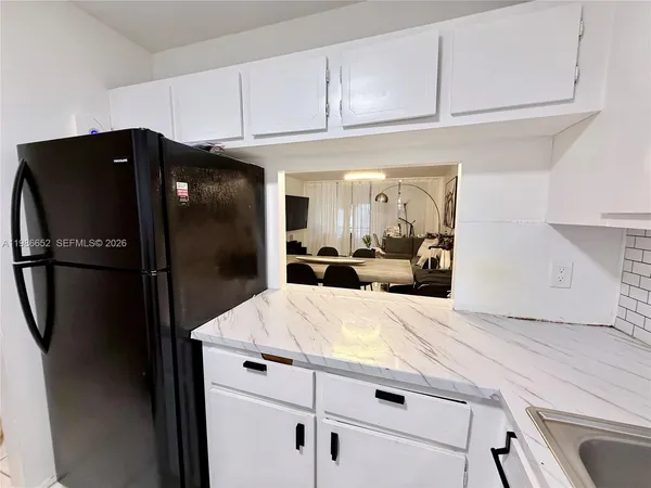 a kitchen with stainless steel appliances a refrigerator and a sink