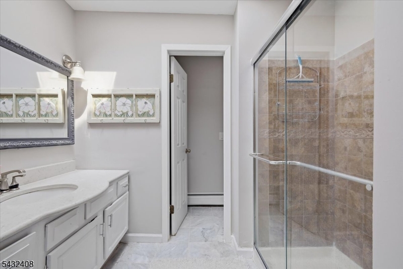 112 Knob Hill Road Hackettstown, NJ 07840 - Photo 23 of 32 a bathroom with a shower sink and mirror