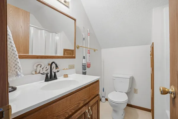 a bathroom with a sink toilet vanity and shower