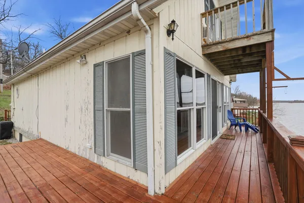 a view of a balcony with wooden floor and fence
