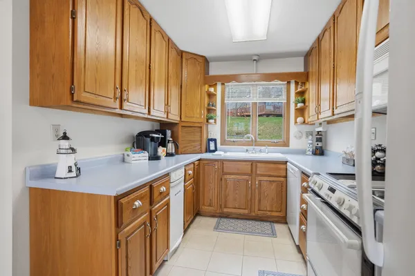 a kitchen with stainless steel appliances granite countertop a sink and a stove