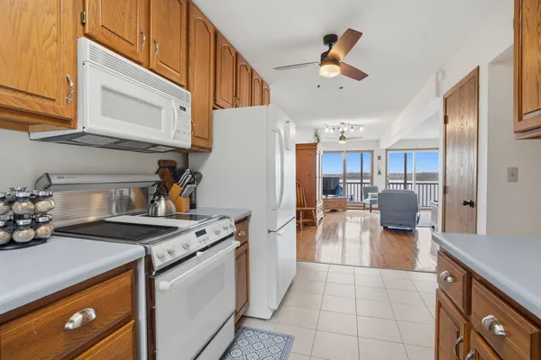 a kitchen with a sink a stove and chairs