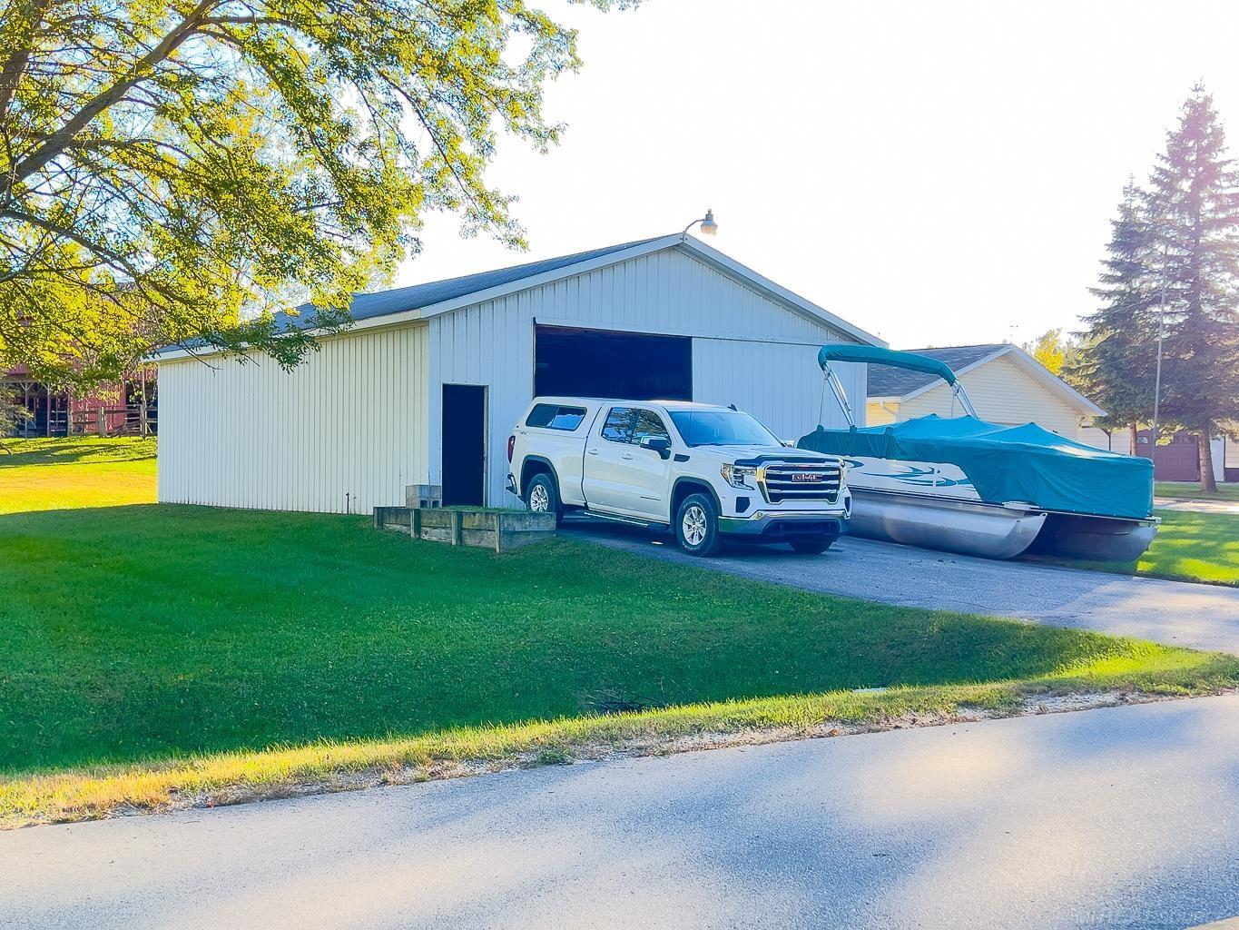 1049 Radov Road Gladwin, MI 48624 - Photo 32 of 40 30x40 pole barn with sliding door 10+ feet high and 12 feet wide. Space for all your toys!