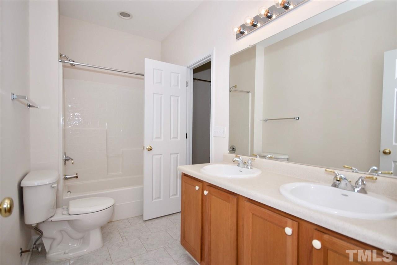 157 Mickleson Ridge Drive Raleigh, NC 27603 - Photo 11 of 30 a spacious bathroom with a double vanity sink toilet mirror and shower
