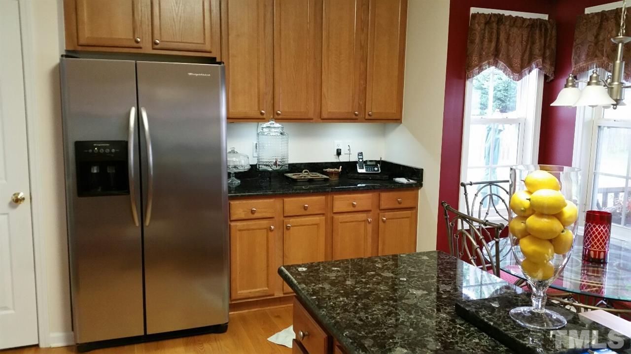 157 Mickleson Ridge Drive Raleigh, NC 27603 - Photo 14 of 30 a kitchen with stainless steel appliances granite countertop a refrigerator sink and stove