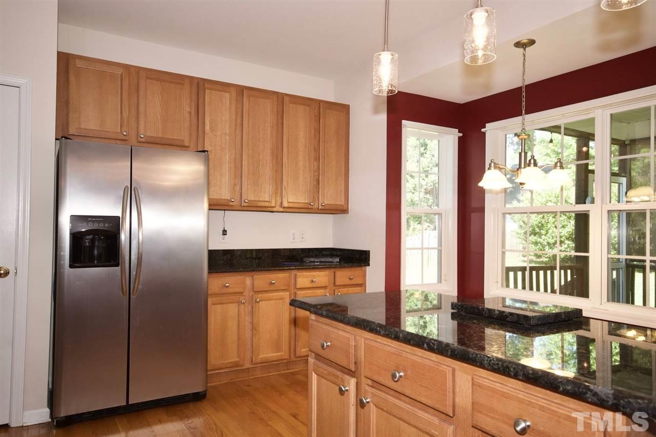 157 Mickleson Ridge Drive Raleigh, NC 27603 - Photo 15 of 30 a kitchen with stainless steel appliances granite countertop a refrigerator a sink and a stove