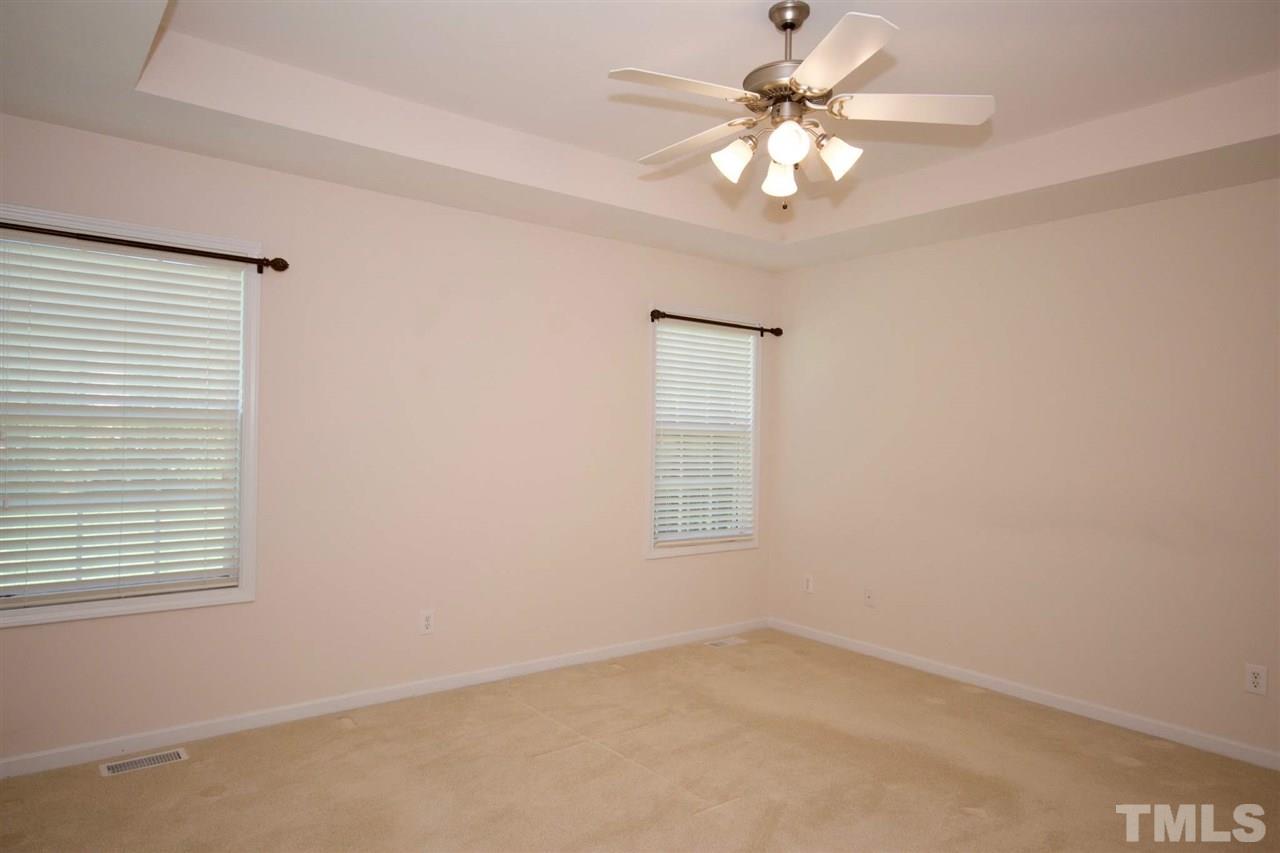 157 Mickleson Ridge Drive Raleigh, NC 27603 - Photo 18 of 30 an empty room with windows and ceiling fan