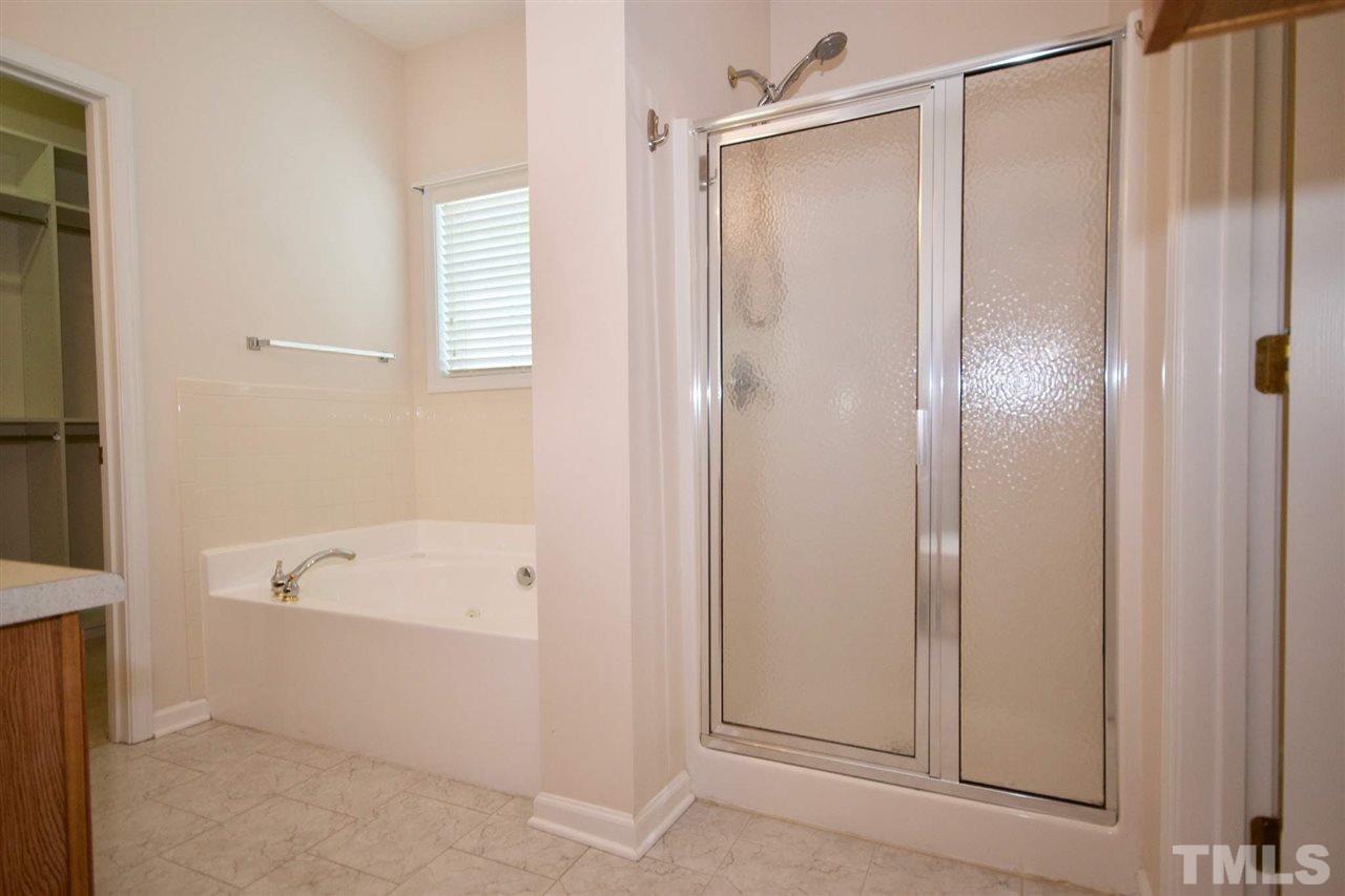 157 Mickleson Ridge Drive Raleigh, NC 27603 - Photo 21 of 30 a bathroom with a tub a shower and a sink