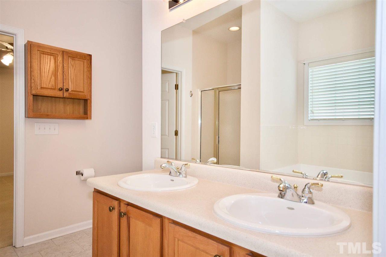 157 Mickleson Ridge Drive Raleigh, NC 27603 - Photo 22 of 30 a bathroom with a sink and a mirror