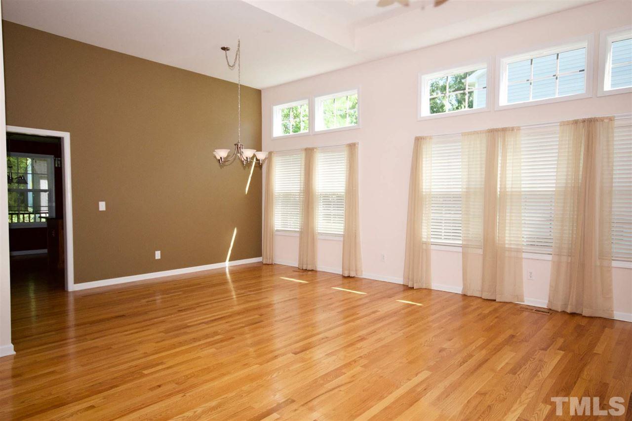 157 Mickleson Ridge Drive Raleigh, NC 27603 - Photo 6 of 30 a view of an empty room with window and wooden floor