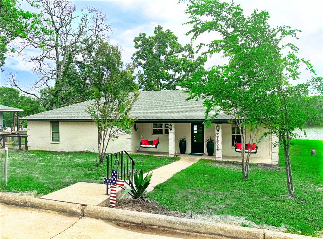 a front view of a house with a yard table and chairs