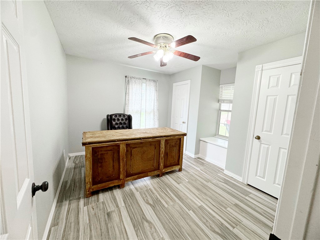 9462 Riley Green Road Franklin, TX 77856 - Photo 11 of 45 a bedroom with a bed and a chandelier