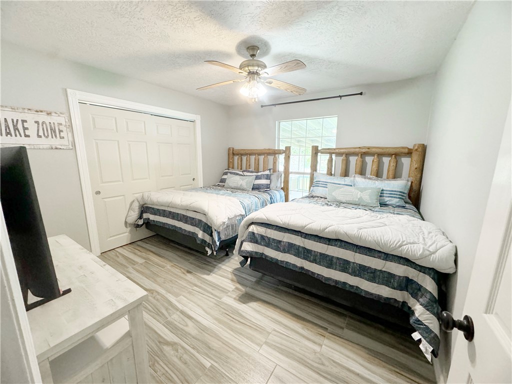 9462 Riley Green Road Franklin, TX 77856 - Photo 12 of 30 a bedroom with two beds and a ceiling fan