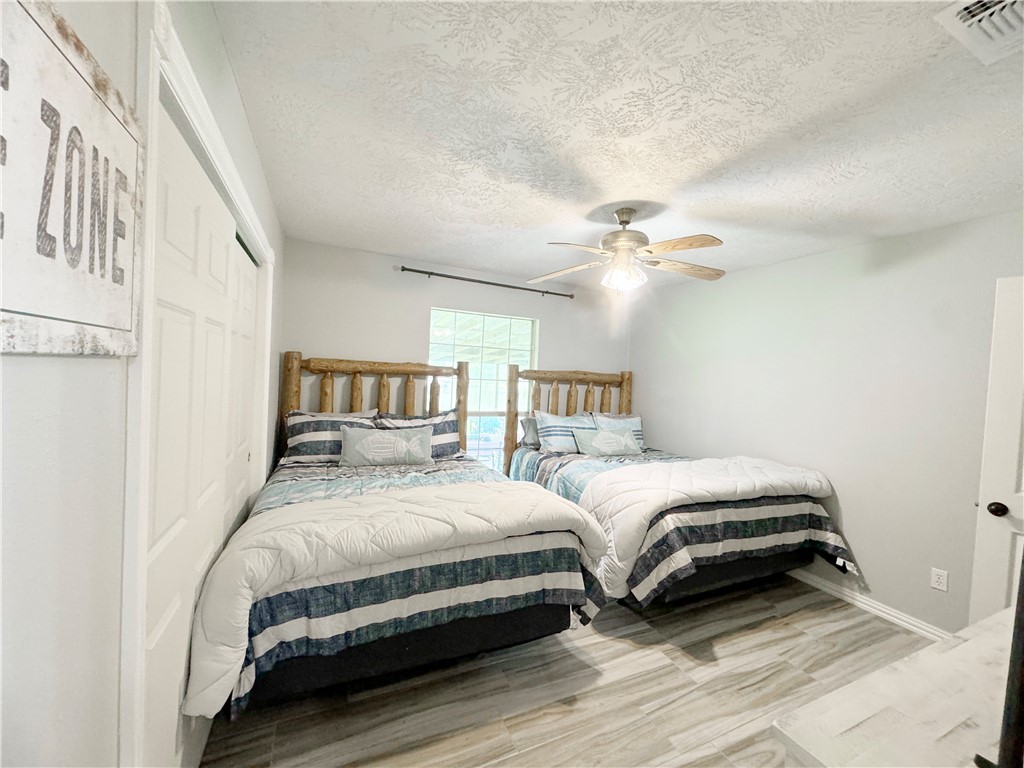 9462 Riley Green Road Franklin, TX 77856 - Photo 13 of 30 a bedroom with a bed and a ceiling fan