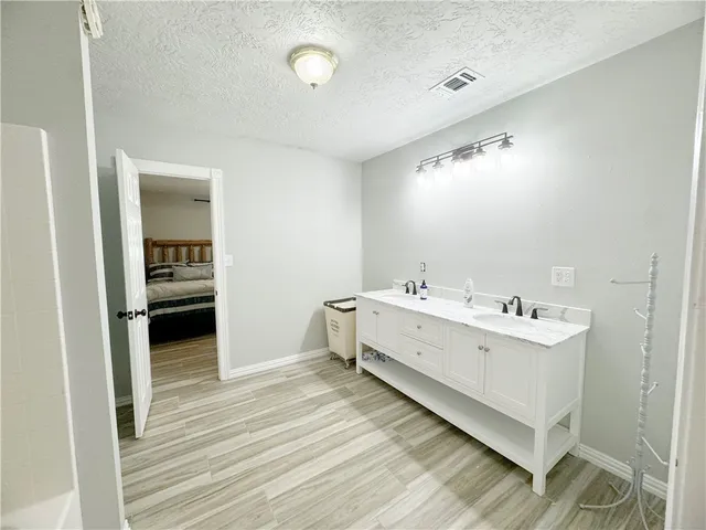 a kitchen with white cabinets and white appliances