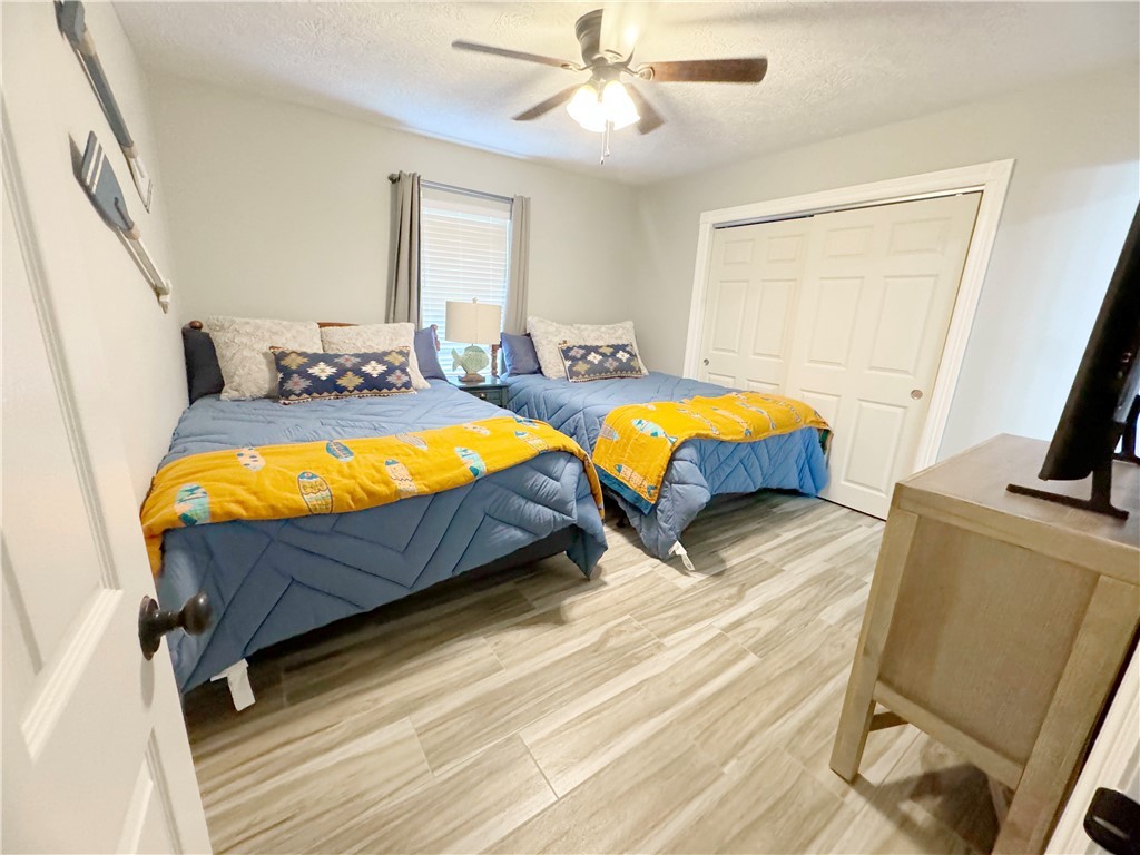 9462 Riley Green Road Franklin, TX 77856 - Photo 15 of 30 a bedroom with 2 bed and a flat tv screen on dresser