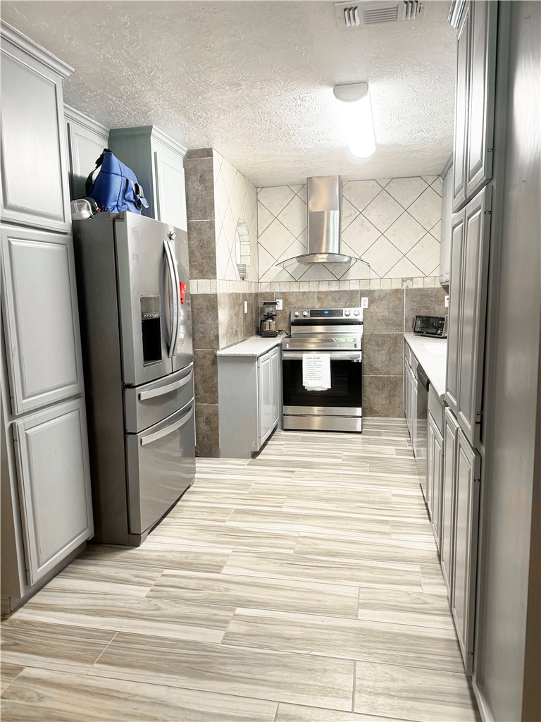 9462 Riley Green Road Franklin, TX 77856 - Photo 20 of 45 a kitchen with stainless steel appliances a refrigerator sink and stove