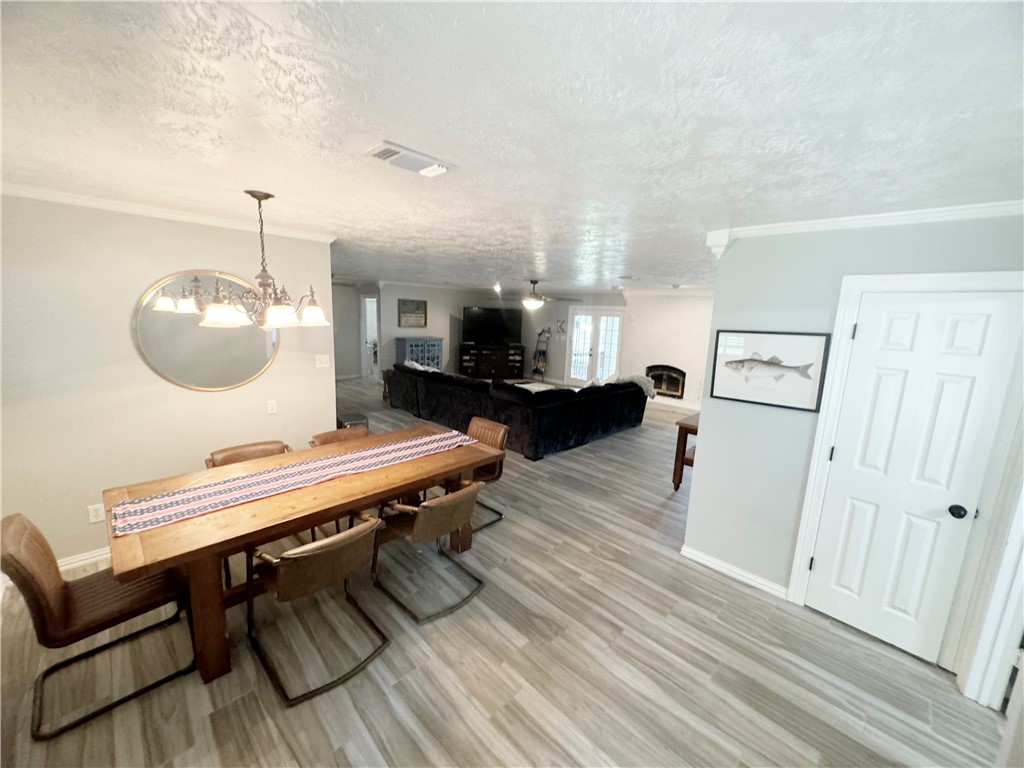 9462 Riley Green Road Franklin, TX 77856 - Photo 23 of 45 a living room with furniture a rug and a chandelier