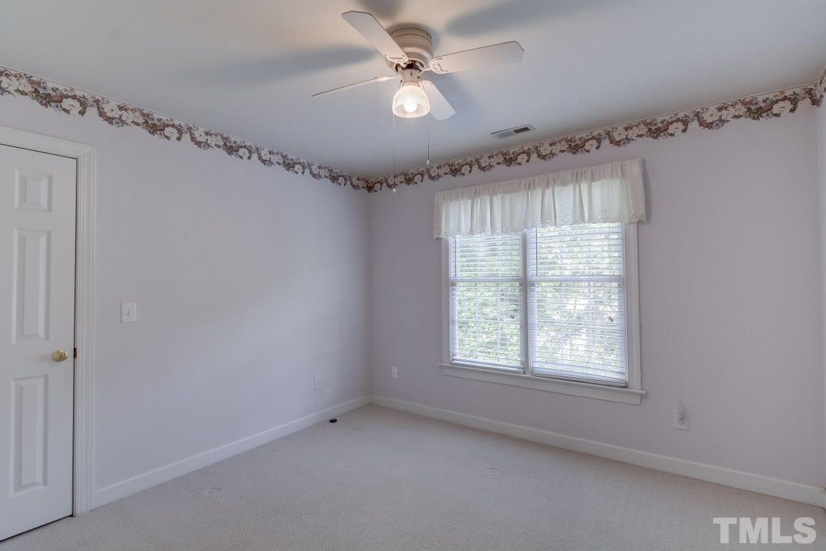 7913 Mayapple Place Raleigh, NC 27613 - Photo 13 of 20 a view of an empty room with a window