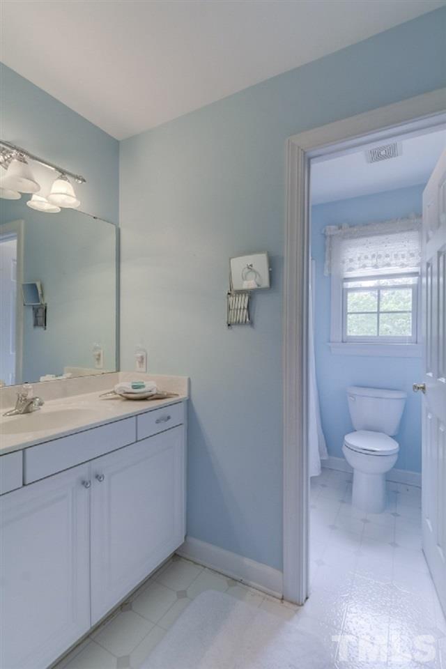 7913 Mayapple Place Raleigh, NC 27613 - Photo 15 of 20 a bathroom with a granite countertop sink mirror and toilet