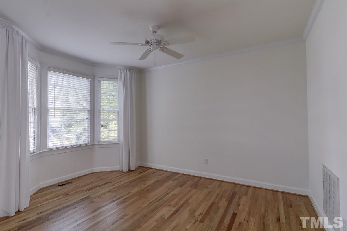7913 Mayapple Place Raleigh, NC 27613 - Photo 5 of 20 an empty room with wooden floor closet and windows