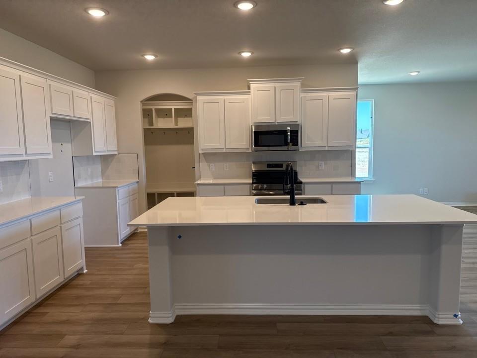 1325 Frio Drive Springtown, TX 76082 - Photo 3 of 10 a kitchen with kitchen island stainless steel appliances sink and cabinets
