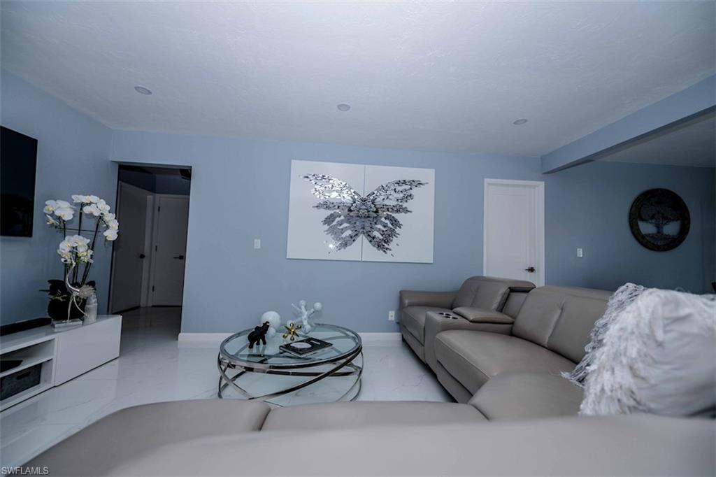 2137 44th Street Southwest Naples, FL 34116 - Photo 15 of 50 Living area with marble finish floor and baseboards