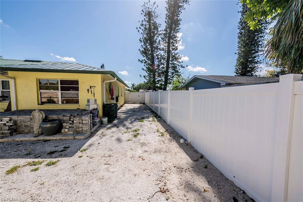 2137 44th Street Southwest Naples, FL 34116 - Photo 45 of 50 View of side of property featuring a patio, a fenced backyard, and stucco siding