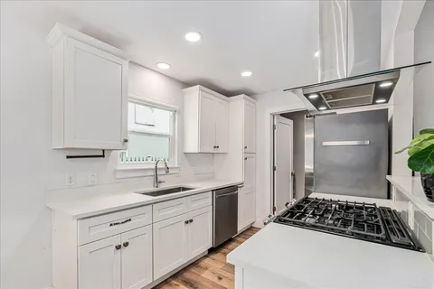 a kitchen with a sink stove and refrigerator