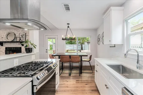 a kitchen with a sink cabinets and window