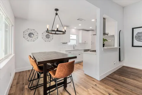 a kitchen with a table and chairs in it