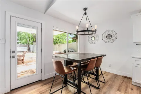 a view of a dining room with furniture window and wooden floor