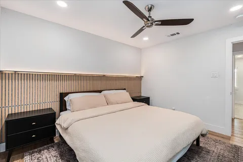 a bedroom with a bed and a night stand