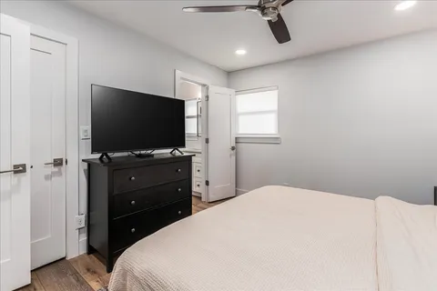 a bedroom with a bed and a flat screen tv