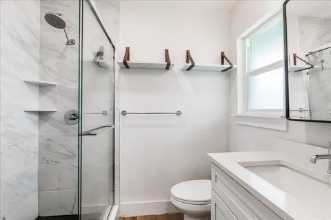 a bathroom with a sink toilet and shower