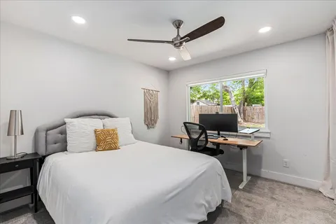 a bedroom with a bed and a desk
