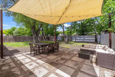 a view of a sitting area with furniture in backyard