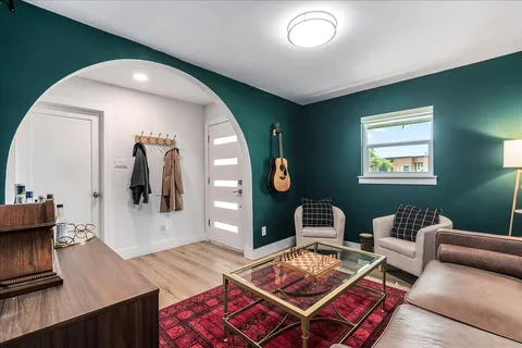 a living room with furniture and wooden floor